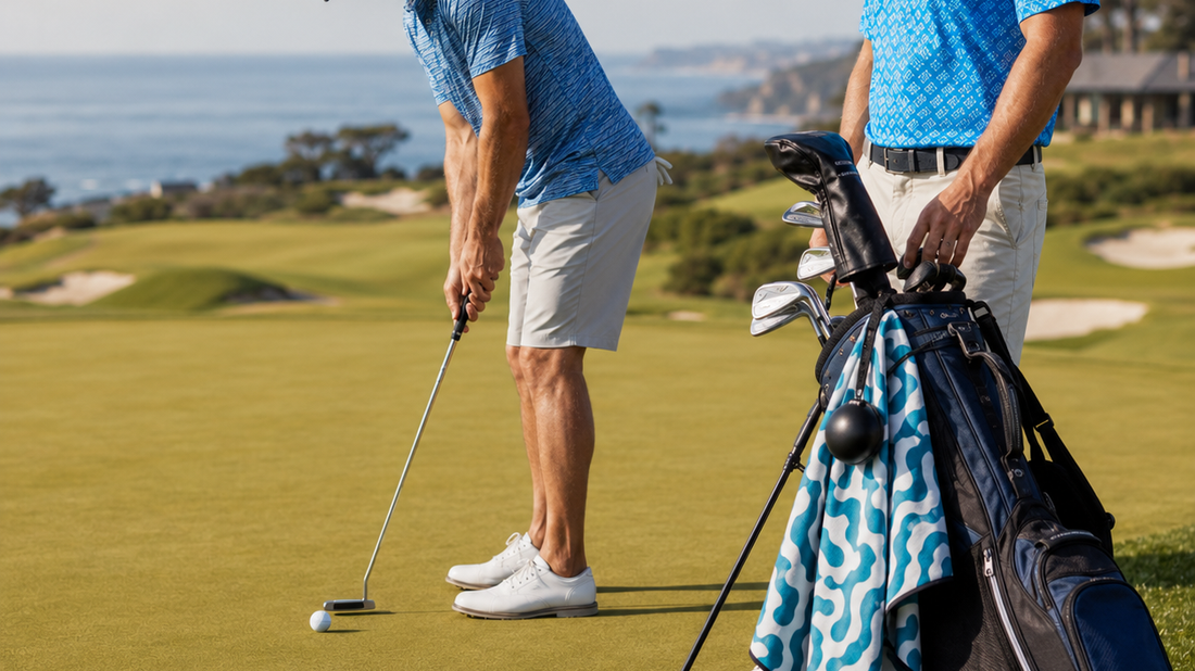 Golf bag with a magnetic golf towel clipped on beside a golfer putting on a seaside green